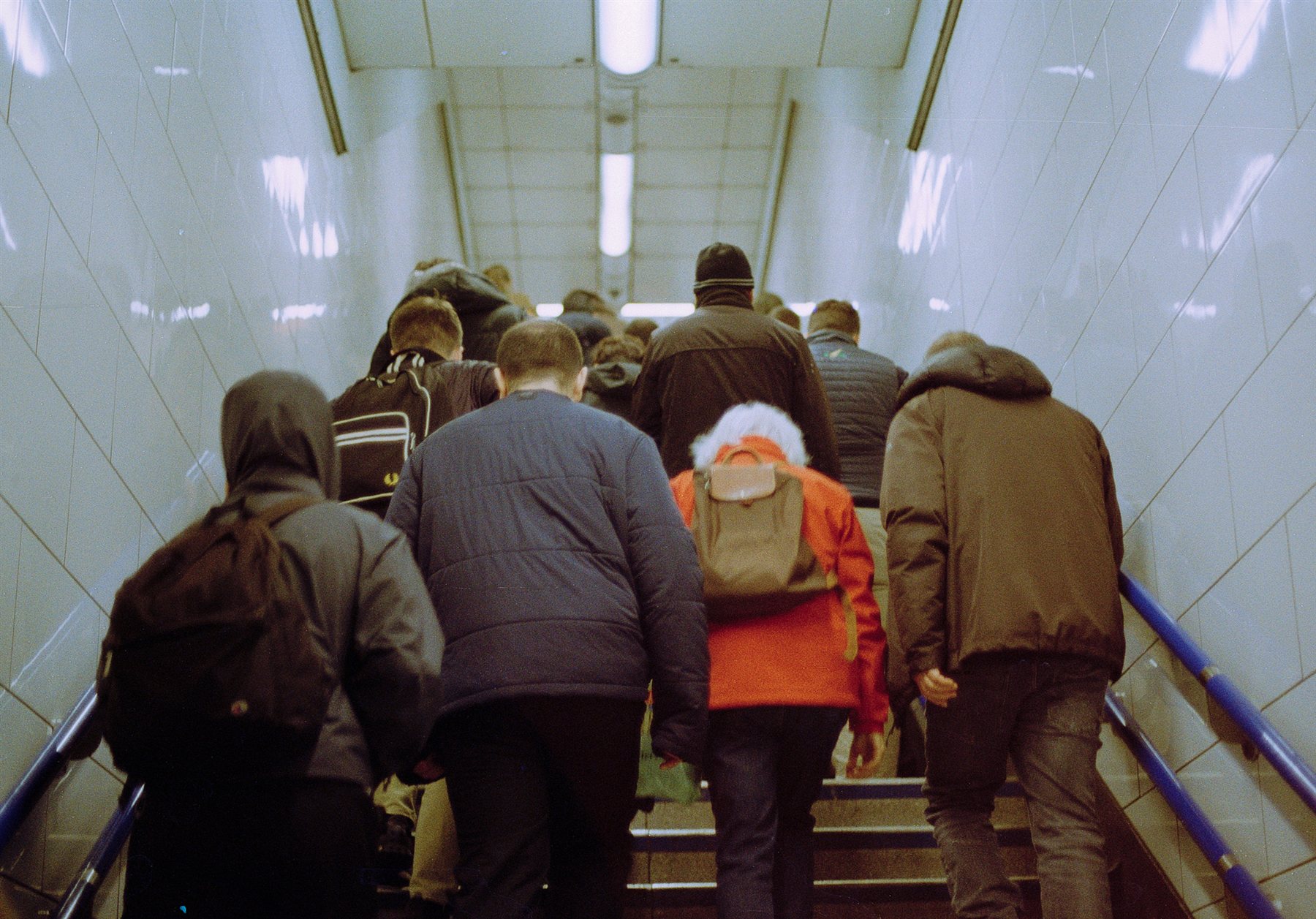 Commuters climbing an Underground staircase seen from behind